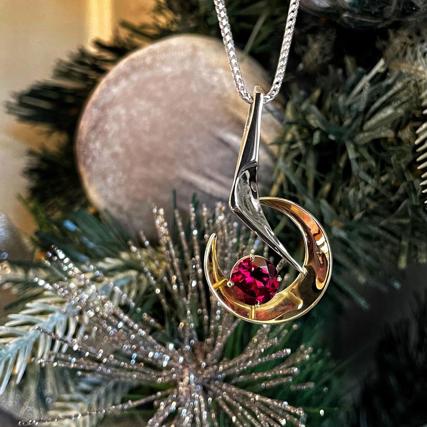 Photo of Garnet Pendant in a decorative scene, designed by , available at Plumb Gold & Plumb Silver