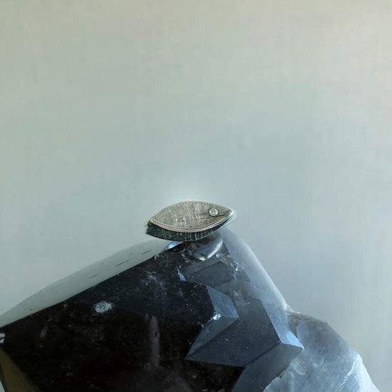 Photo of Gemoetric Leaf Ring with Diamond Accent in a decorative scene, designed by , available at Plumb Gold & Plumb Silver