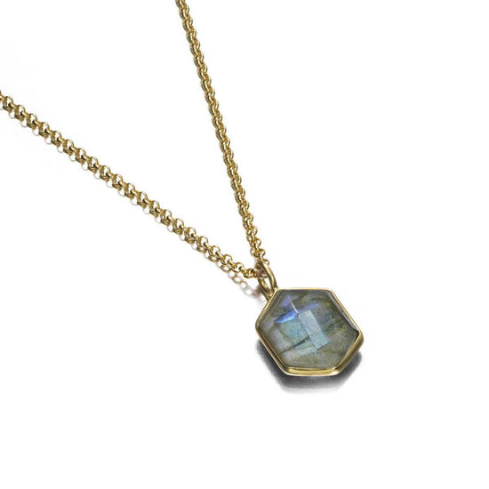 Photo of “Geo” Labradorite Pendant in a decorative scene, designed by , available at Plumb Gold & Plumb Silver