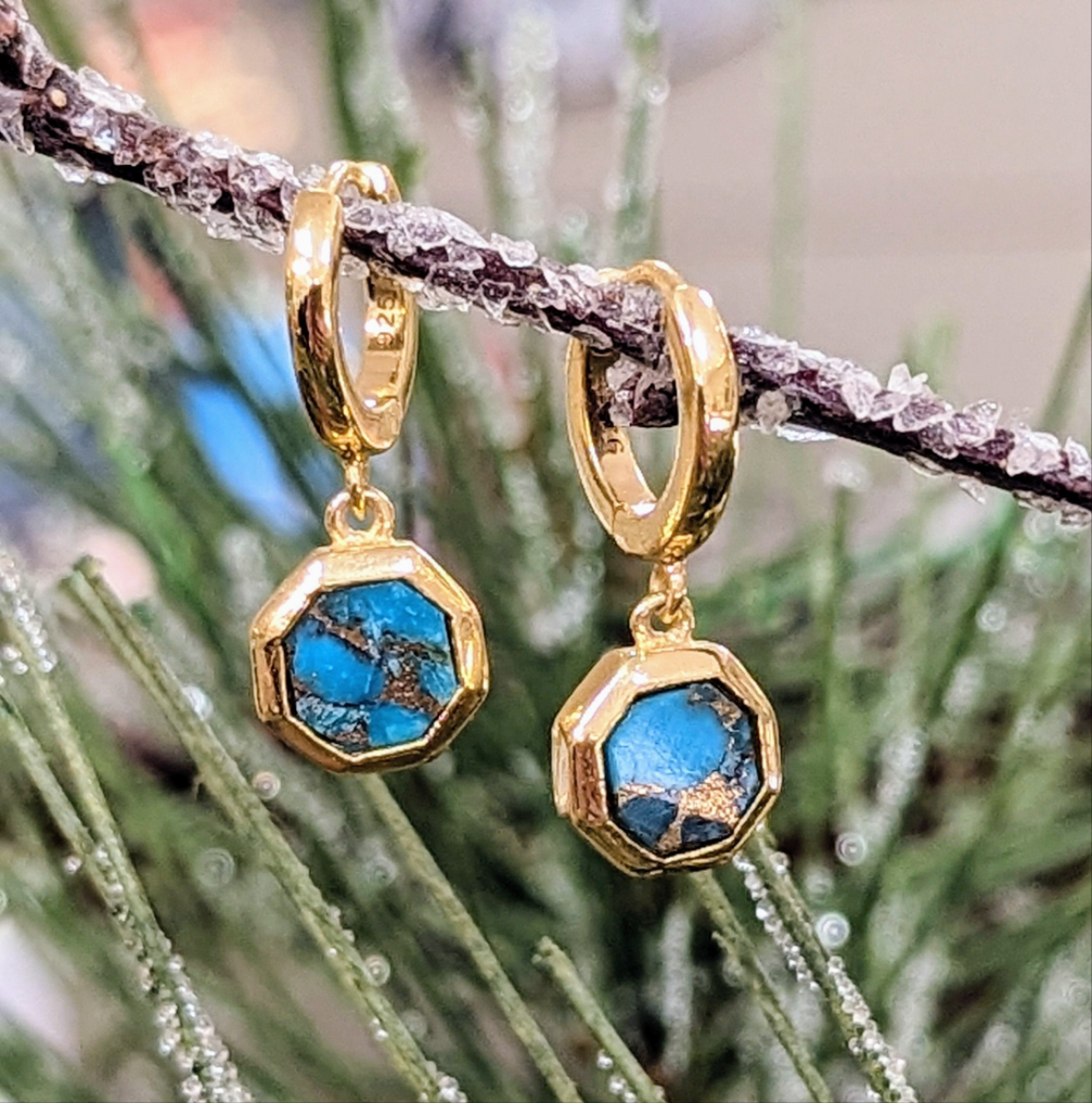 Photo of "Geo" Turquoise Dangle Hoop Earrings in a decorative scene, designed by , available at Plumb Gold & Plumb Silver