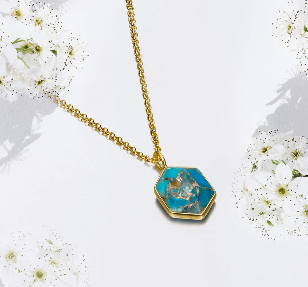 Photo of "Geo" Turquoise Pendant in a decorative scene, designed by , available at Plumb Gold & Plumb Silver