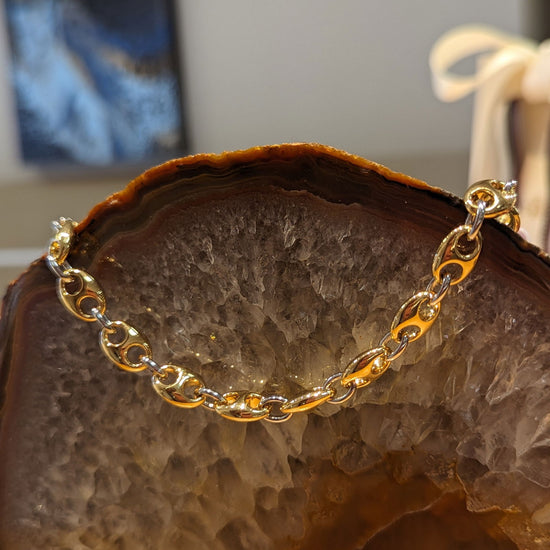 Photo of Gold Plated Mariner link bracelet in a decorative scene, designed by , available at Plumb Gold & Plumb Silver