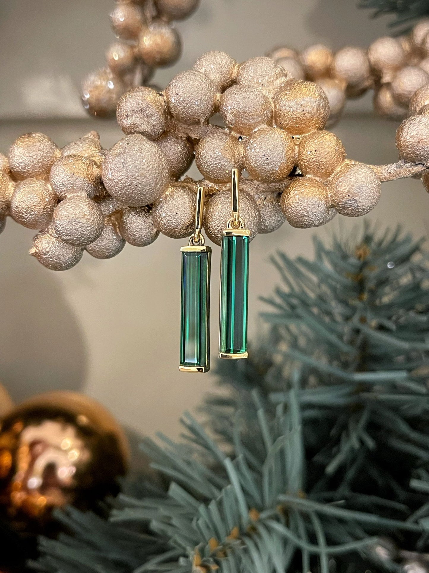 Photo of Green Tourmaline Dangles in a decorative scene, designed by , available at Plumb Gold & Plumb Silver