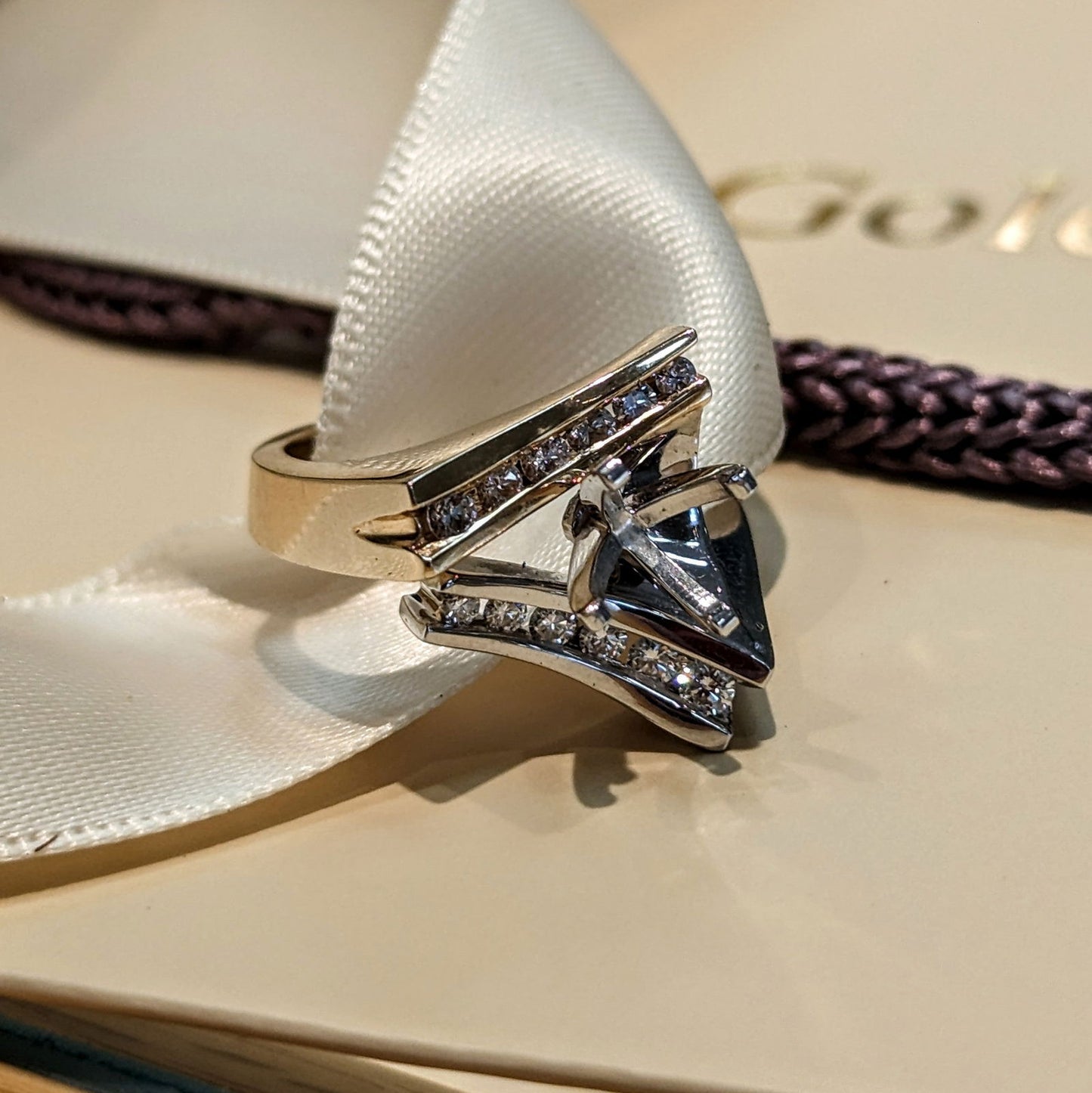 Photo of HL asymmetric Ring Mounting in a decorative scene, designed by , available at Plumb Gold & Plumb Silver
