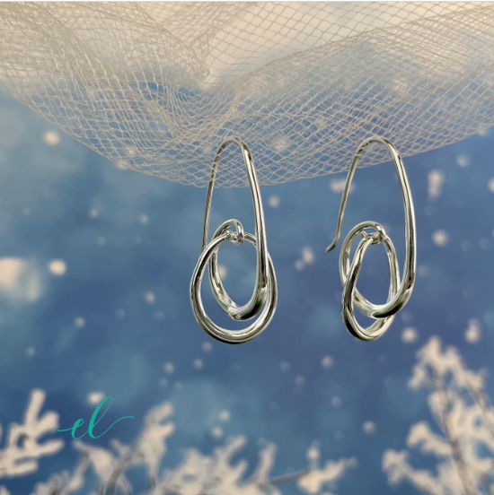 Photo of "Halo" Earrings in a decorative scene, designed by , available at Plumb Gold & Plumb Silver