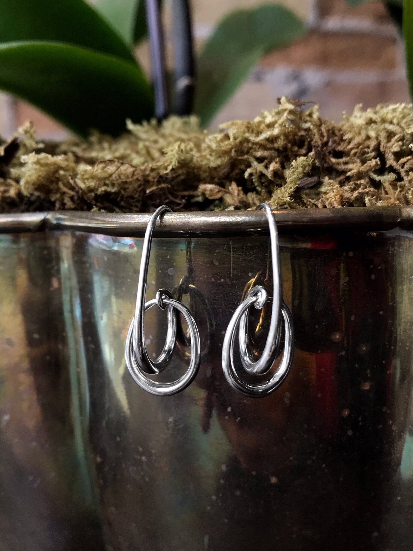 Photo of "Halo" Earrings in a decorative scene, designed by , available at Plumb Gold & Plumb Silver