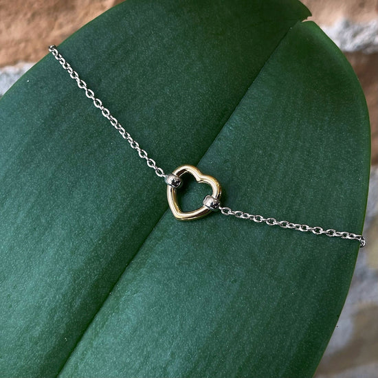 Photo of Heart Bracelet in a decorative scene, designed by , available at Plumb Gold & Plumb Silver