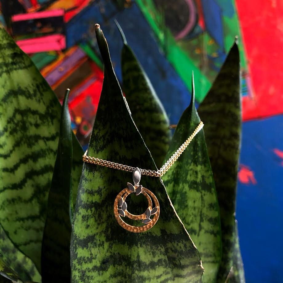 Photo of "Hebe" Pendant in a decorative scene, designed by , available at Plumb Gold & Plumb Silver