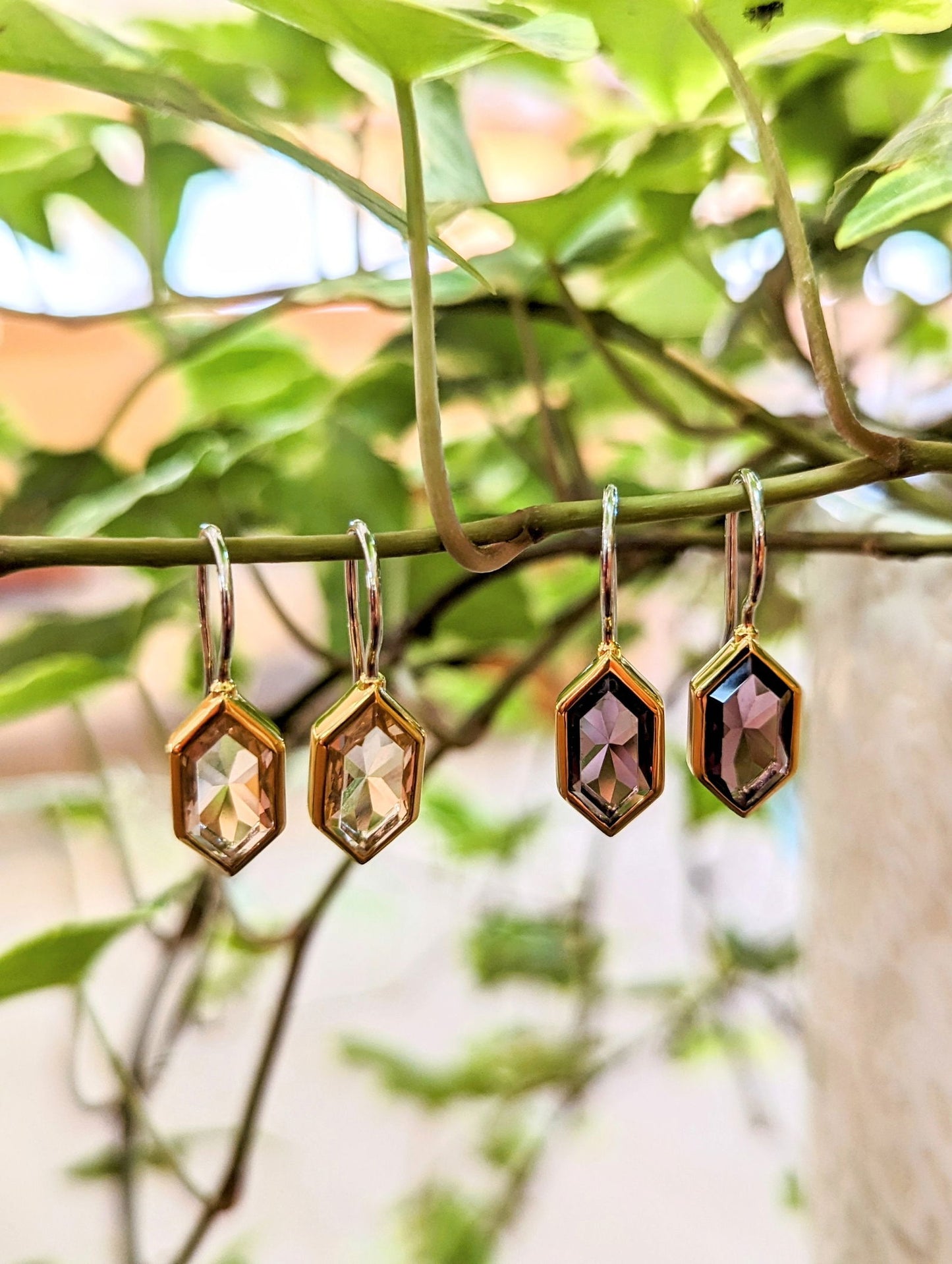 Photo of Hex Drop Earrings in a decorative scene, designed by , available at Plumb Gold & Plumb Silver