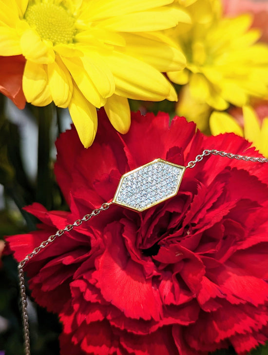 Photo of Hexagon Pave CZ Bracelet in a decorative scene, designed by , available at Plumb Gold & Plumb Silver