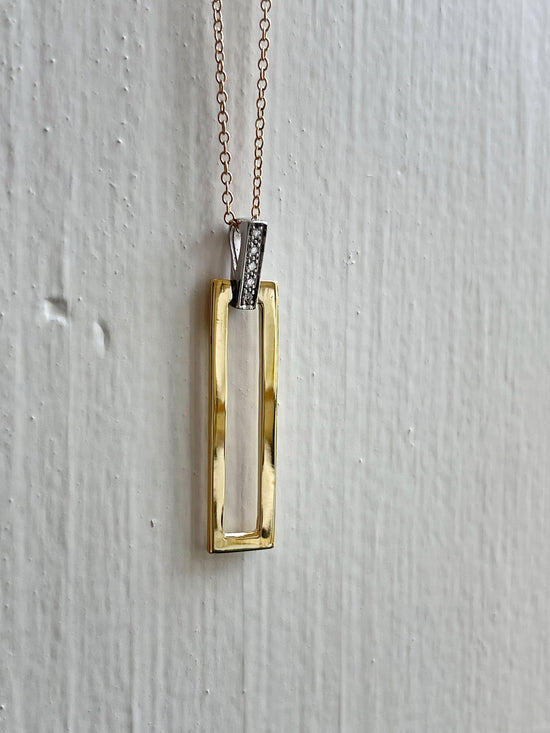 Photo of I.Reiss Open Rectangle Necklace in a decorative scene, designed by , available at Plumb Gold & Plumb Silver