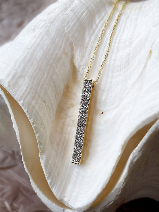 Photo of I. Reiss Diamond Bar Necklace in a decorative scene, designed by , available at Plumb Gold & Plumb Silver