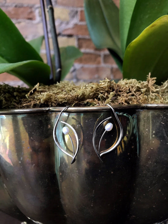 Photo of "Jonquil" Earrings in a decorative scene, designed by , available at Plumb Gold & Plumb Silver