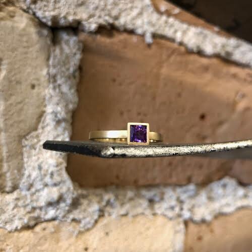 Photo of Kim Collins Amethyst Yum Drop in a decorative scene, designed by , available at Plumb Gold & Plumb Silver