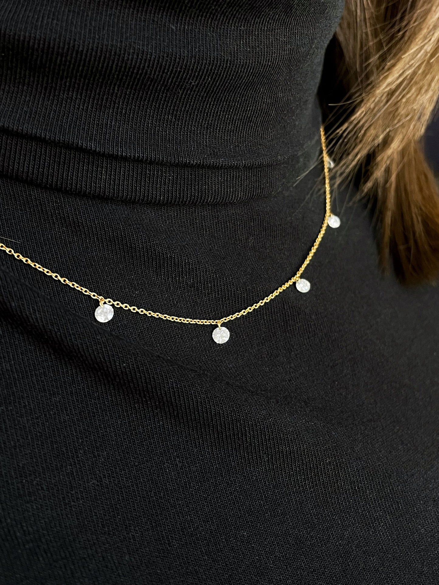 Photo of Kim Collins Dancing Diamond Necklace in a decorative scene, designed by , available at Plumb Gold & Plumb Silver
