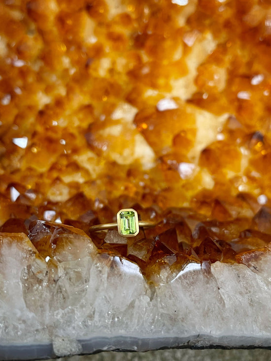 Photo of Kim Collins Peridot Yumdrop in a decorative scene, designed by , available at Plumb Gold & Plumb Silver