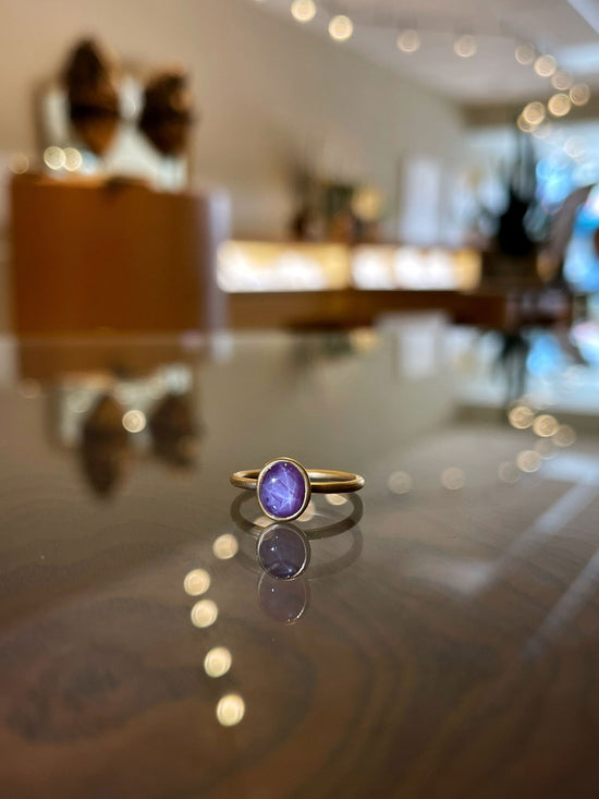 Photo of Kim Collins Star Ruby Yumdrop in a decorative scene, designed by , available at Plumb Gold & Plumb Silver