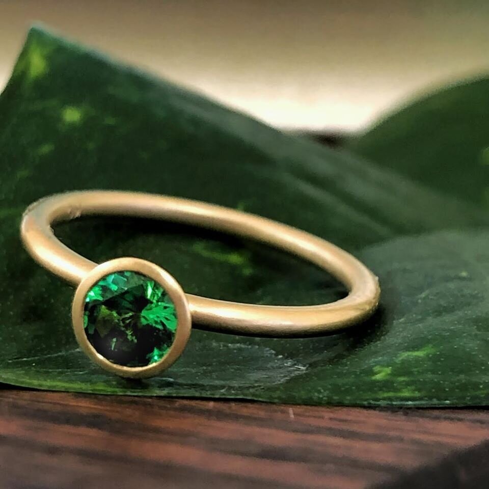 Photo of Kim Collins Tsavorite Yum Drop in a decorative scene, designed by , available at Plumb Gold & Plumb Silver