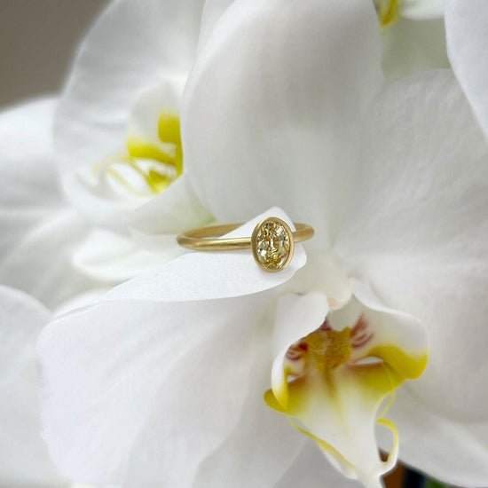 Photo of Kim Collins Yellow Sapphire Yumdrop in a decorative scene, designed by , available at Plumb Gold & Plumb Silver