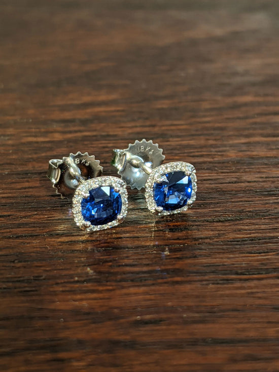 Photo of Kimberly Collins Blue Sapphire and Diamond Studs in a decorative scene, designed by , available at Plumb Gold & Plumb Silver