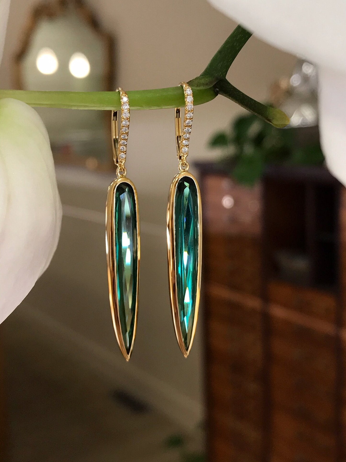 Photo of Kimberly Collins Green Tourmaline "Spike" Dangle in a decorative scene, designed by , available at Plumb Gold & Plumb Silver