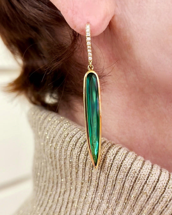 Photo of Kimberly Collins Green Tourmaline "Spike" Dangle in a decorative scene, designed by , available at Plumb Gold & Plumb Silver