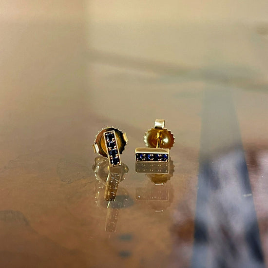 Photo of Kimberly Collins Stick Studs in a decorative scene, designed by , available at Plumb Gold & Plumb Silver