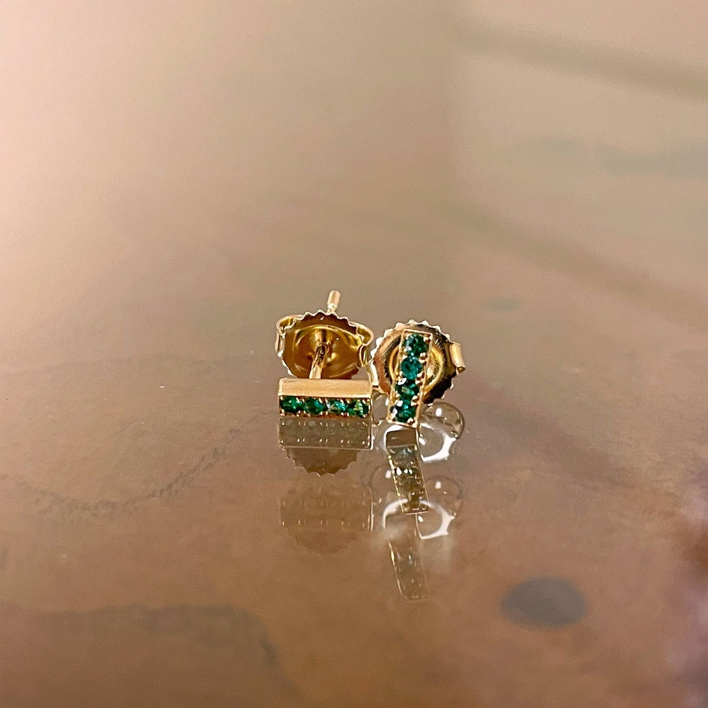 Photo of Kimberly Collins Stick Studs in a decorative scene, designed by , available at Plumb Gold & Plumb Silver
