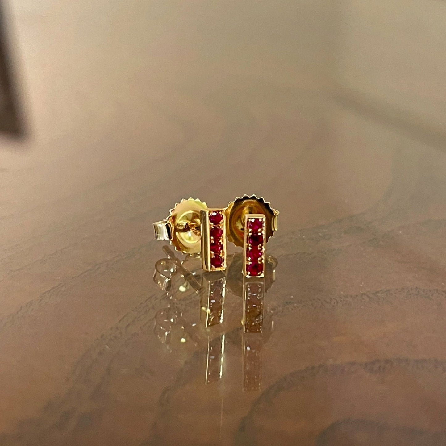 Photo of Kimberly Collins Stick Studs in a decorative scene, designed by , available at Plumb Gold & Plumb Silver