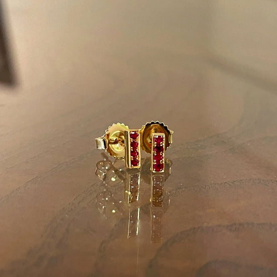 Photo of Kimberly Collins Stick Studs in a decorative scene, designed by , available at Plumb Gold & Plumb Silver