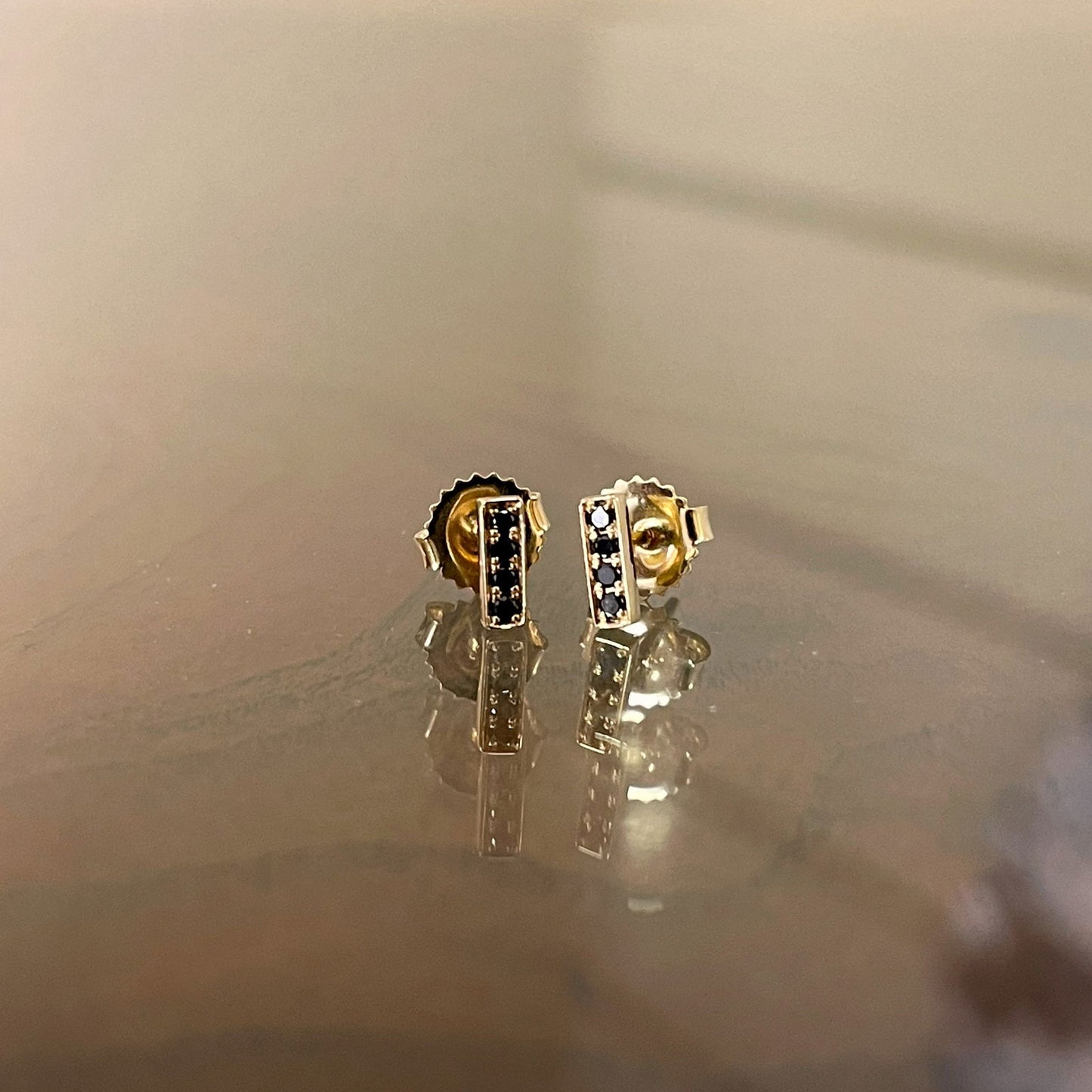Photo of Kimberly Collins Stick Studs in a decorative scene, designed by , available at Plumb Gold & Plumb Silver