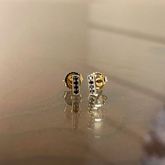 Photo of Kimberly Collins Stick Studs in a decorative scene, designed by , available at Plumb Gold & Plumb Silver