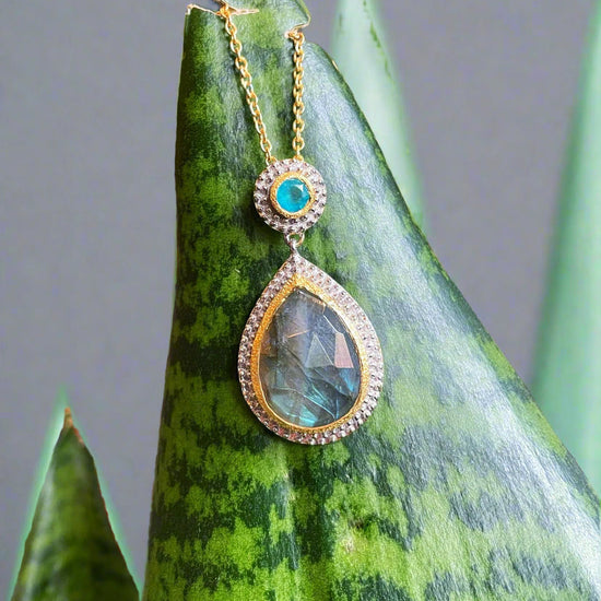 Photo of "Kira" Necklace in a decorative scene, designed by , available at Plumb Gold & Plumb Silver