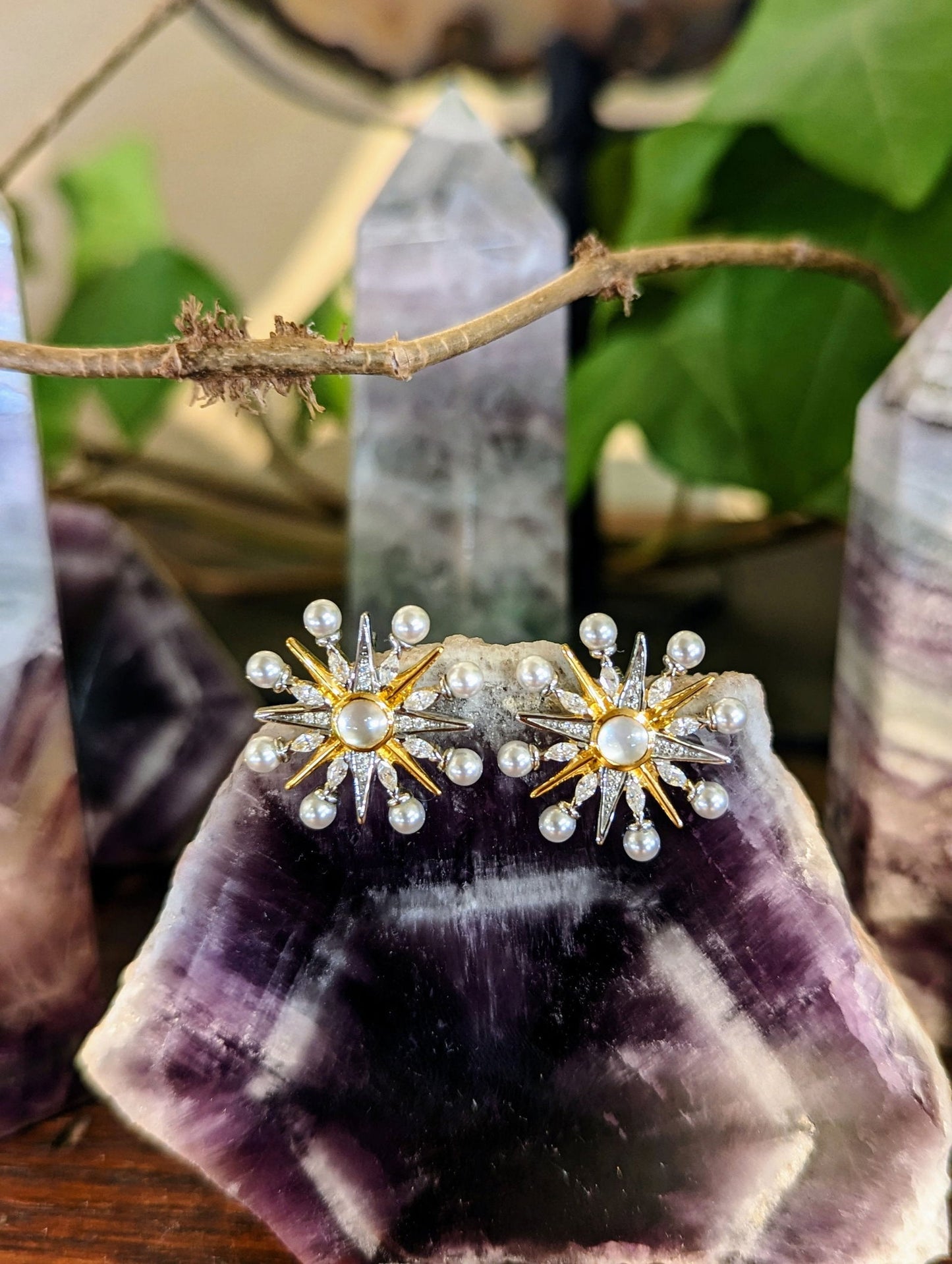 Photo of Large Celestial Stud Earrings in a decorative scene, designed by , available at Plumb Gold & Plumb Silver