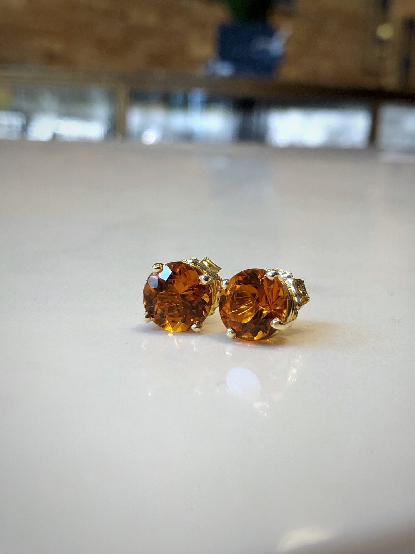 Photo of Large Citrine Studs in a decorative scene, designed by , available at Plumb Gold & Plumb Silver