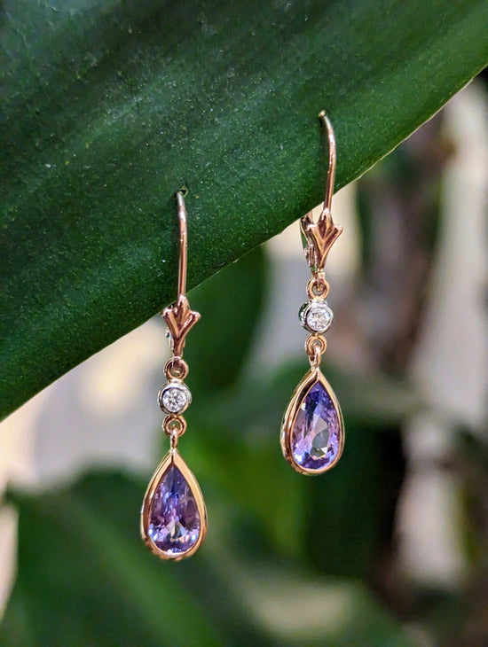 Photo of Lavender Spinel Dangle Earrings in a decorative scene, designed by , available at Plumb Gold & Plumb Silver