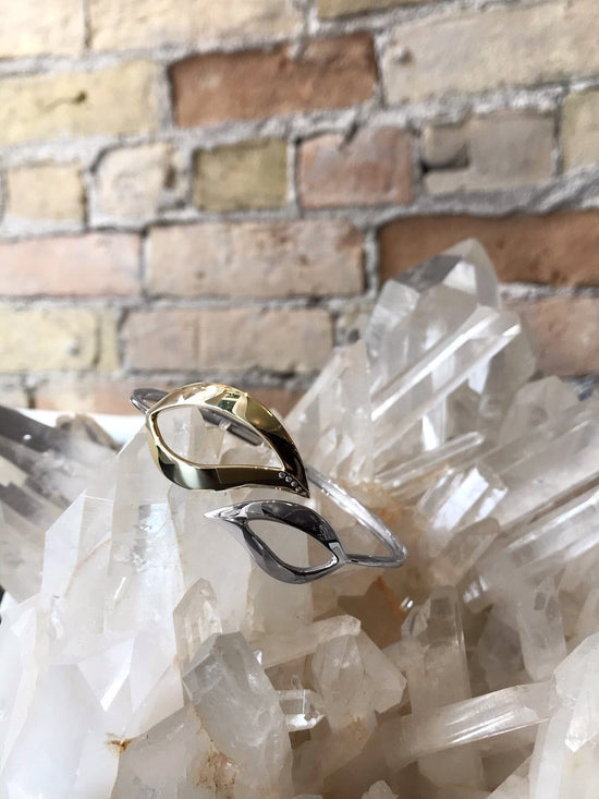 Photo of Leaf Bangle in a decorative scene, designed by , available at Plumb Gold & Plumb Silver