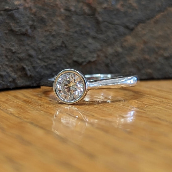 Photo of "Lexi" Engagement Ring Mounting in a decorative scene, designed by , available at Plumb Gold & Plumb Silver