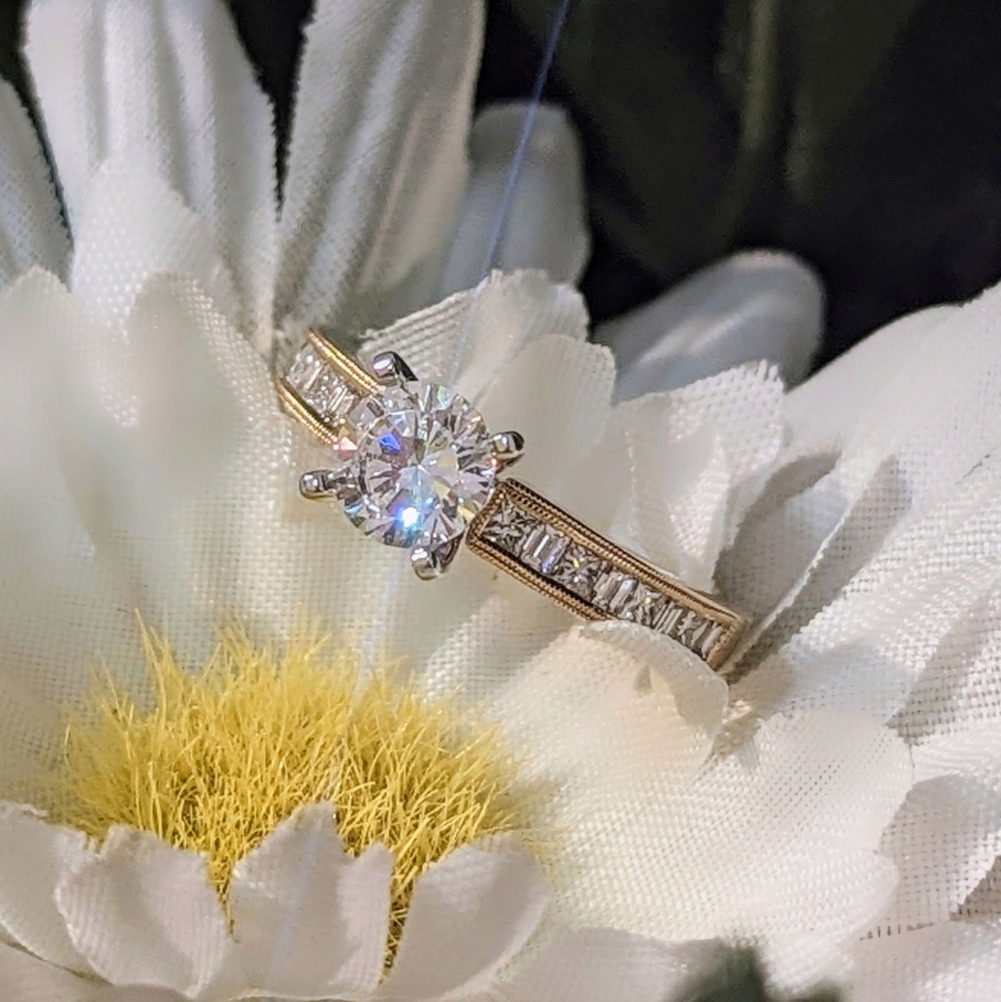 Photo of "Lillian" Princess and Baguette Channel Accented Solitaire Engagement Ring in a decorative scene, designed by , available at Plumb Gold & Plumb Silver