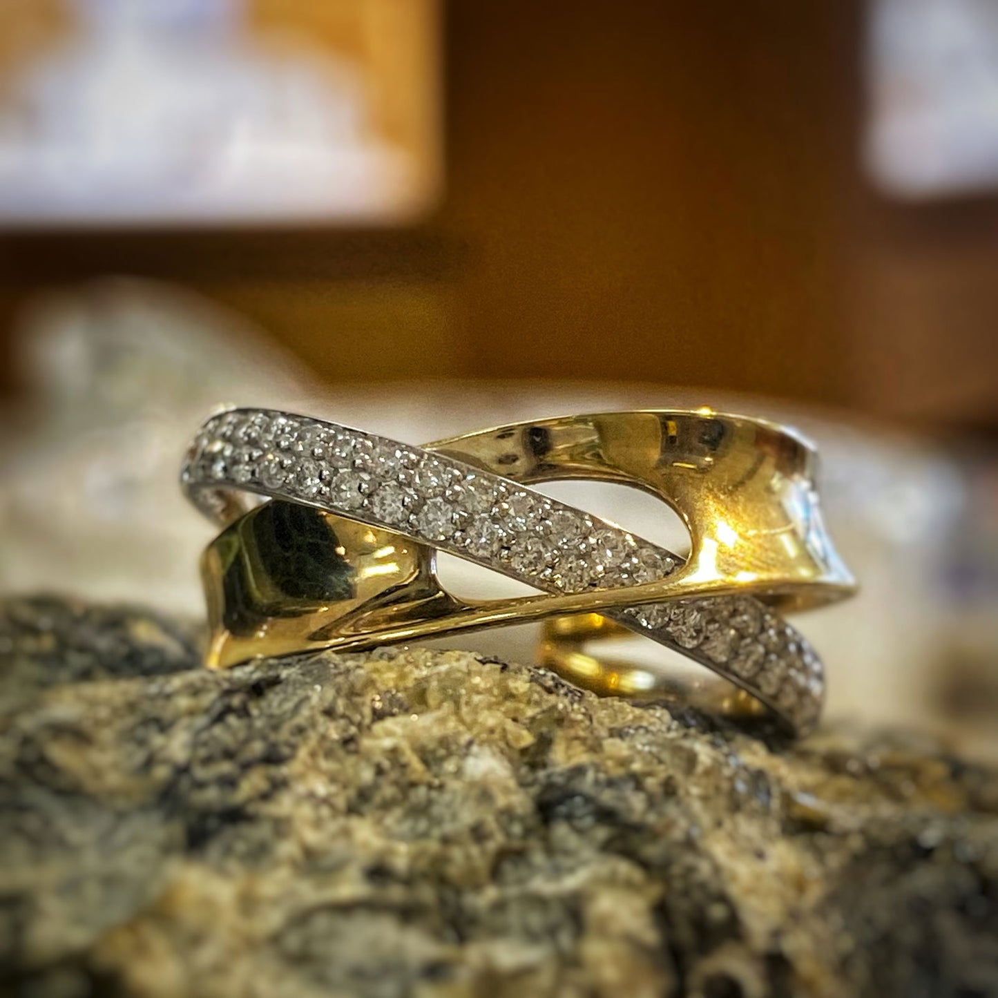 Photo of Looped Diamond and Gold Ring in a decorative scene, designed by , available at Plumb Gold & Plumb Silver
