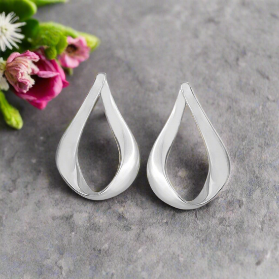 Photo of "Love" Earrings in a decorative scene, designed by -, available at Plumb Gold & Plumb Silver