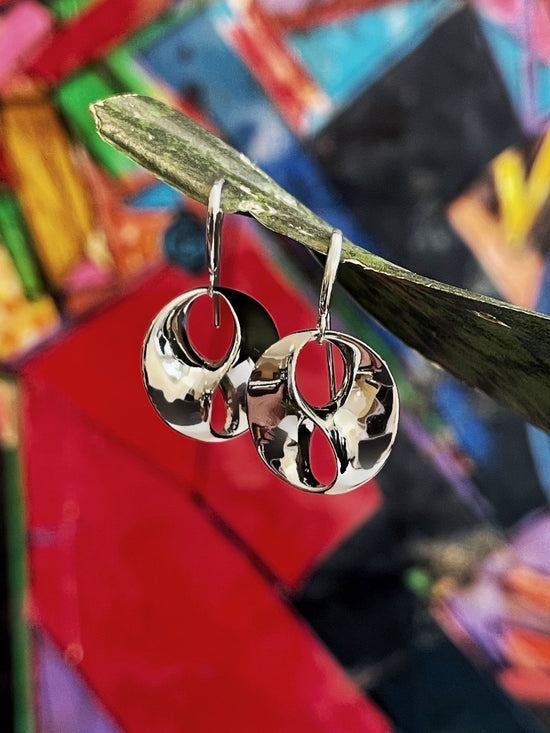 Photo of "Love" Earrings in a decorative scene, designed by , available at Plumb Gold & Plumb Silver