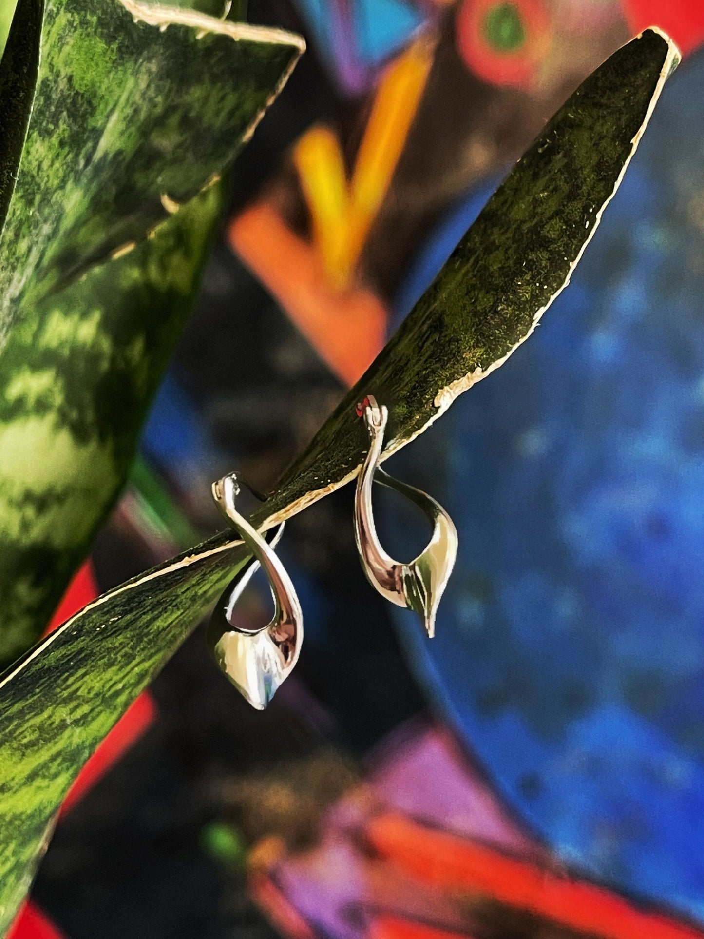 Photo of "Love" Twist Earrings in a decorative scene, designed by , available at Plumb Gold & Plumb Silver