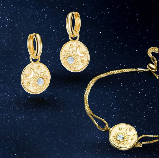 Photo of "Luna" Celestial Dangle Hoop Earrings in a decorative scene, designed by , available at Plumb Gold & Plumb Silver