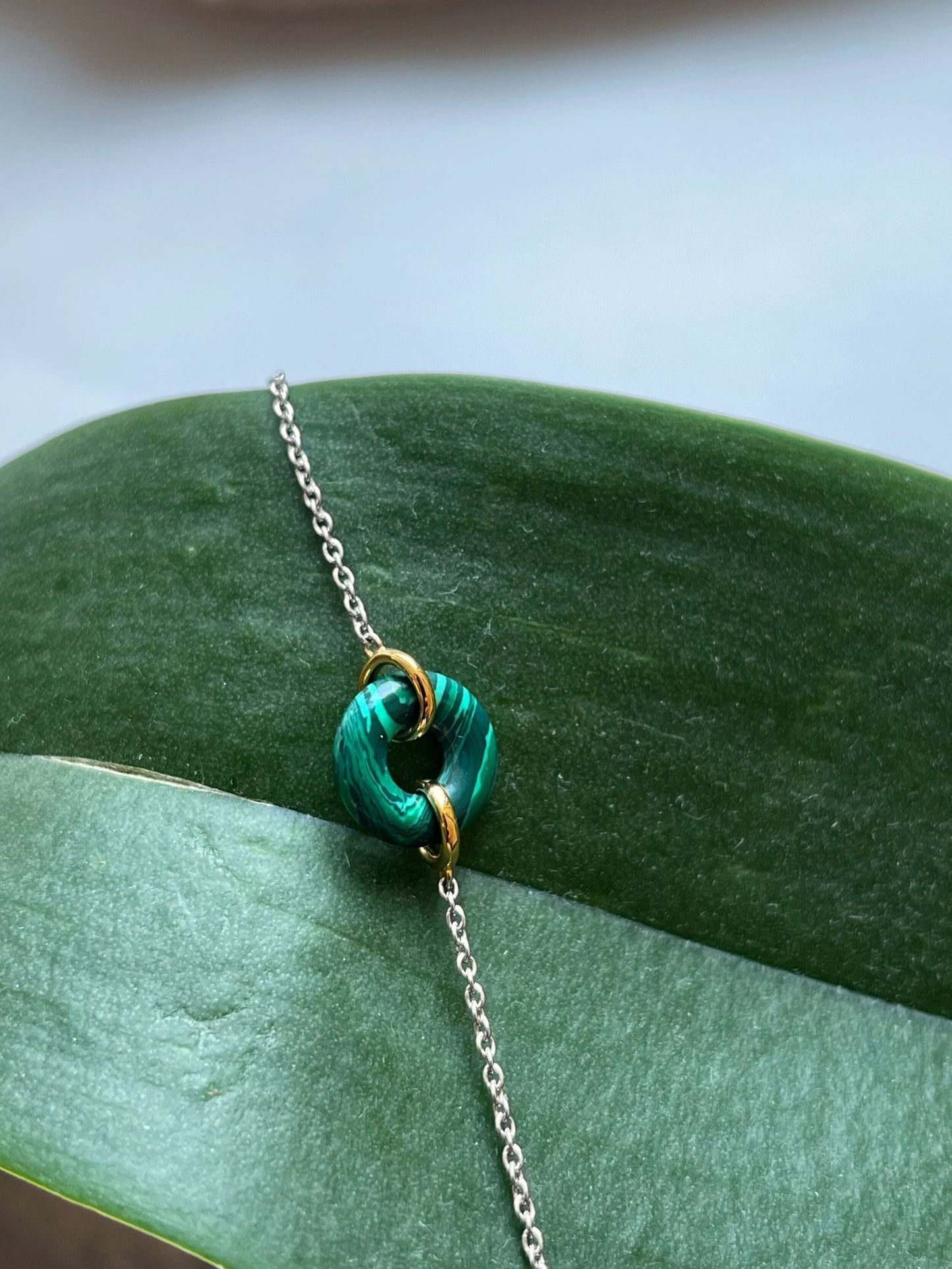 Photo of Malachite Bracelet in a decorative scene, designed by , available at Plumb Gold & Plumb Silver