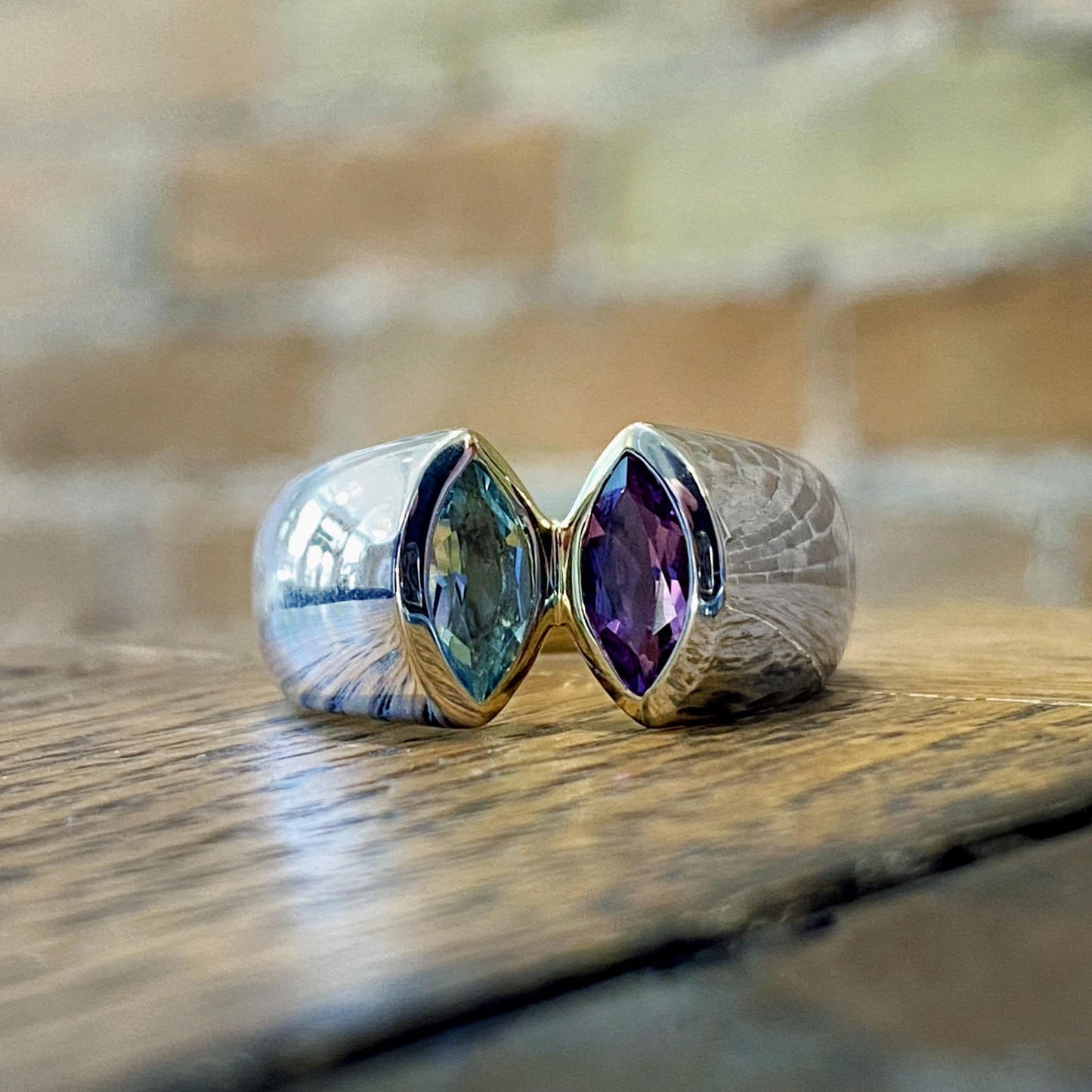 Photo of Marquise Gemstone Ring in a decorative scene, designed by , available at Plumb Gold & Plumb Silver