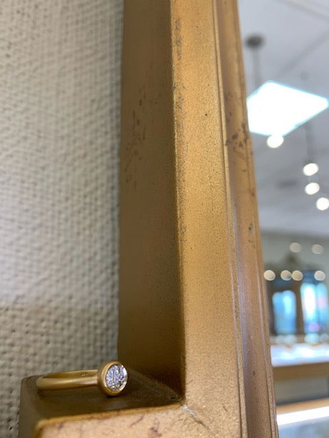 Photo of Matte Pavé Bezel Ring in a decorative scene, designed by , available at Plumb Gold & Plumb Silver
