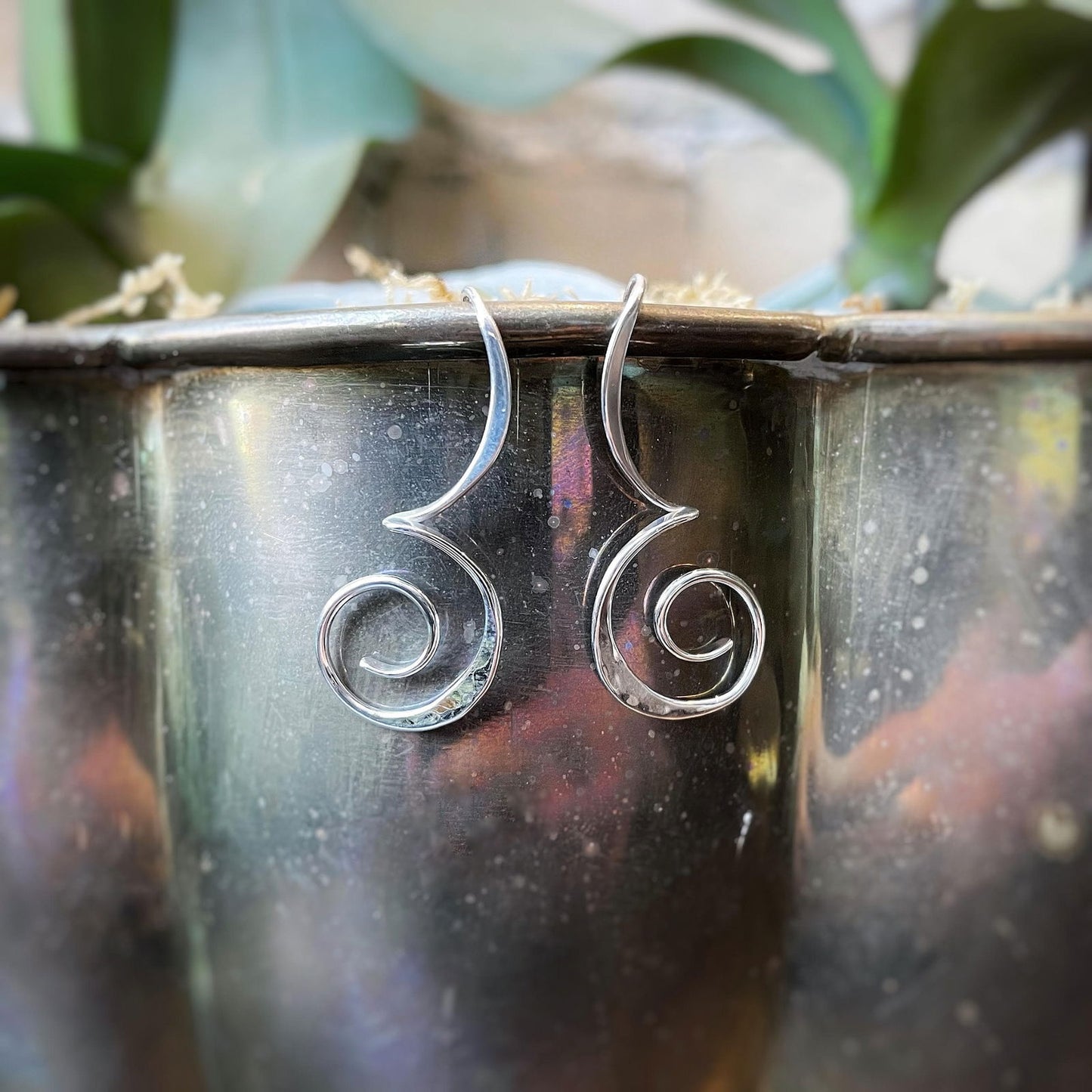 Photo of "Melody" Earrings in a decorative scene, designed by , available at Plumb Gold & Plumb Silver