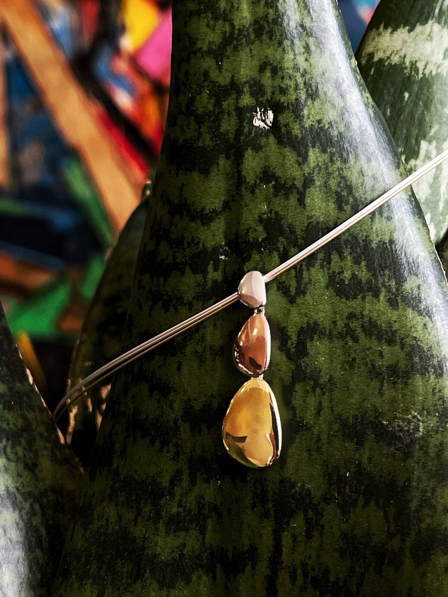 Photo of "Mercury" Multi-tone Pendant in a decorative scene, designed by , available at Plumb Gold & Plumb Silver