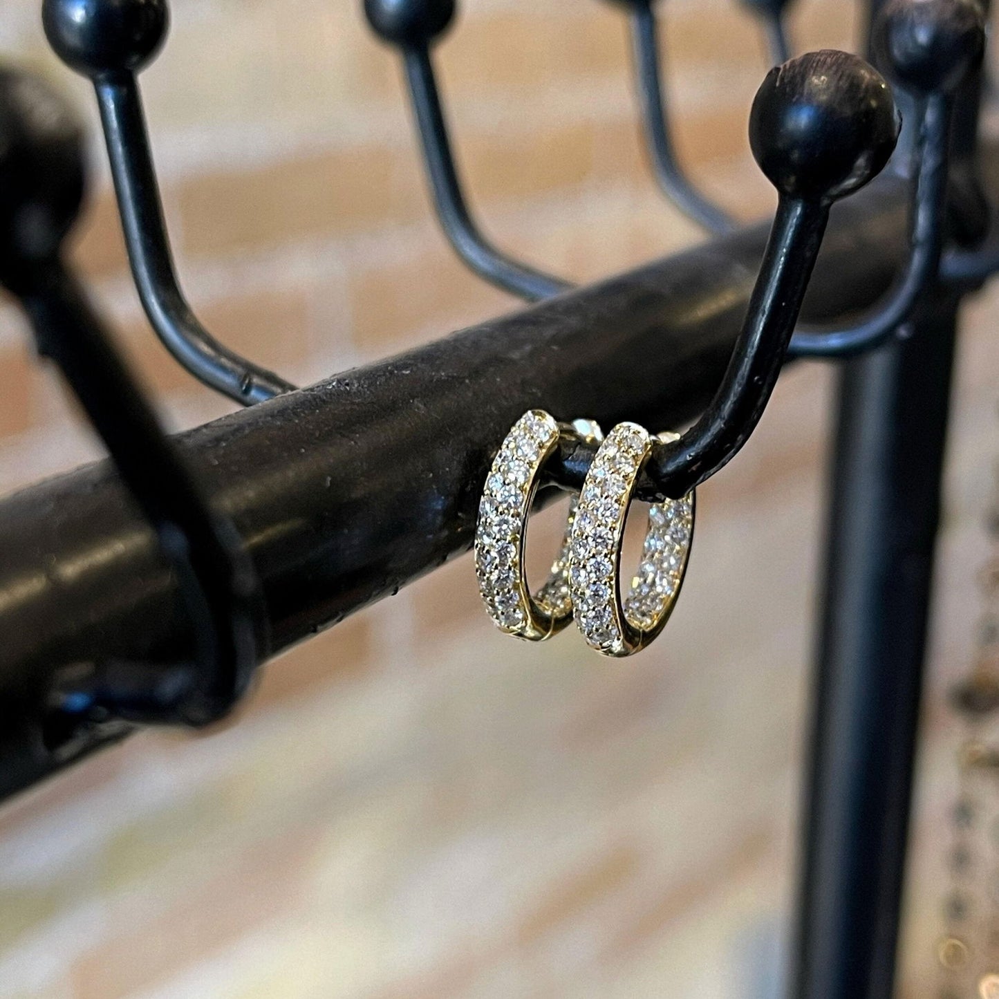 Photo of Mini Inside-Out Diamond Hoops in a decorative scene, designed by , available at Plumb Gold & Plumb Silver